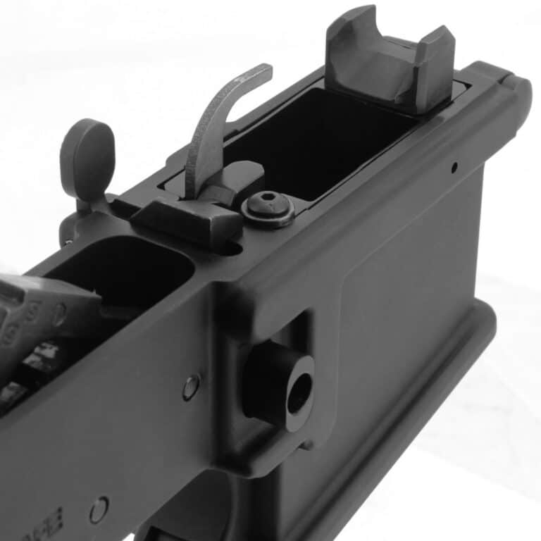 Remove the small screw and washer near the ejector, then slide the adapter into your magazine well.