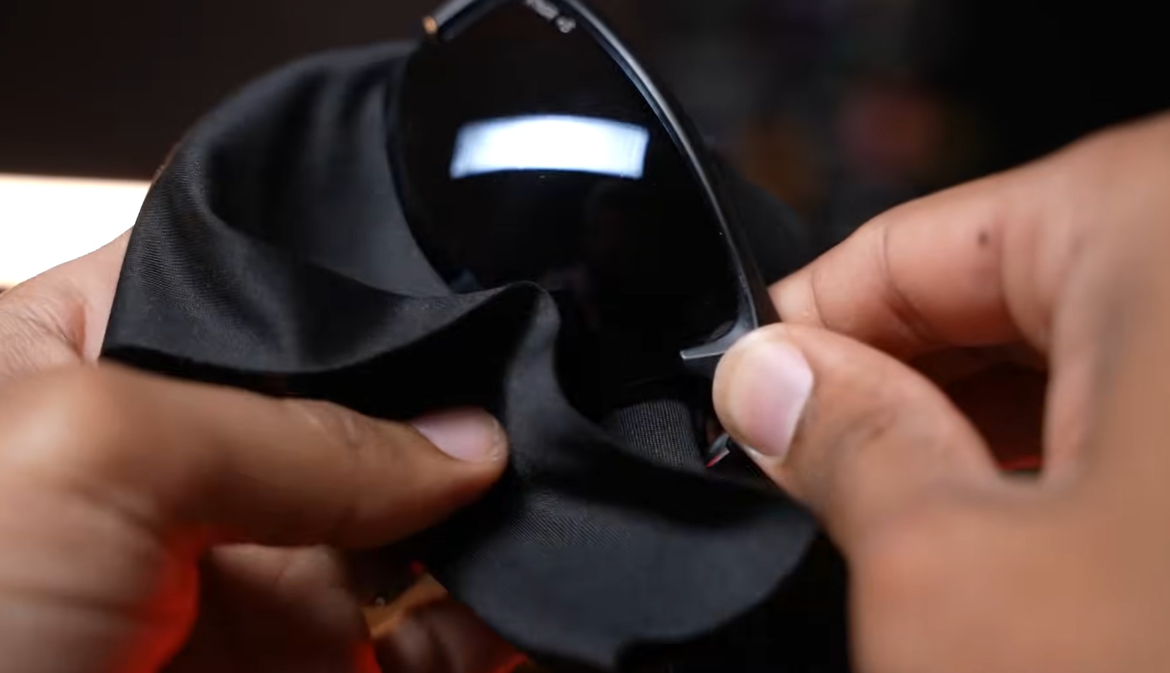 Cleaning shooting glasses with a microfiber cloth