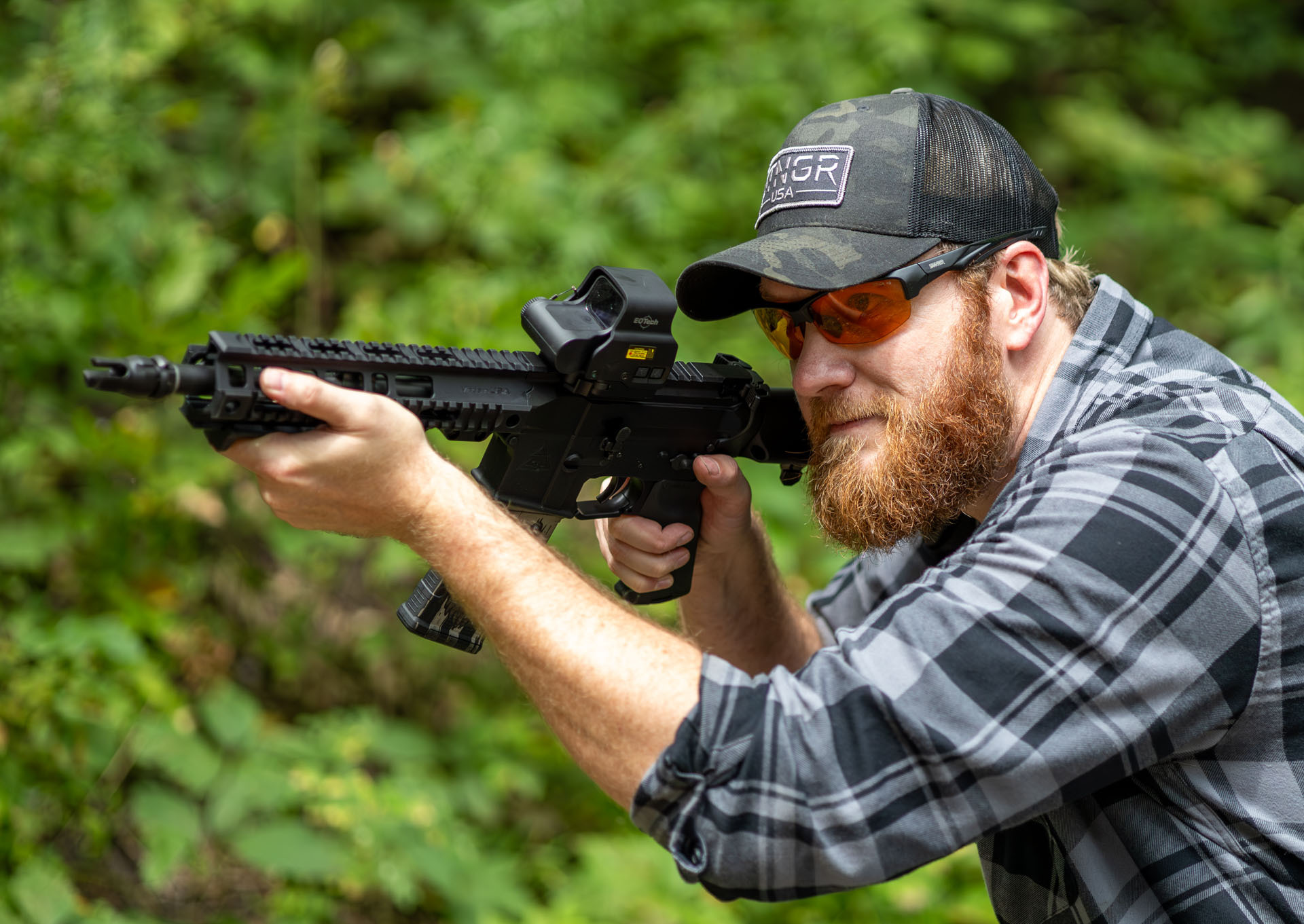 Shooter checking polarized shooting glasses with a red dot sight